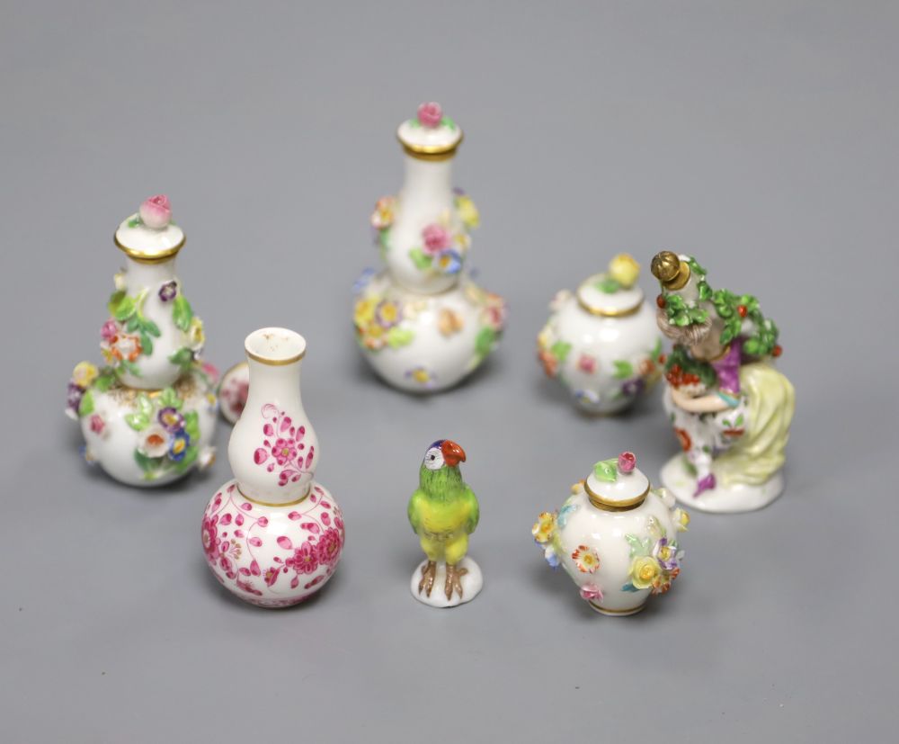 Meissen miniature porcelain - two pairs of flower encrusted vases and covers, a pink floral vase and a model of a parrot, crossed sword